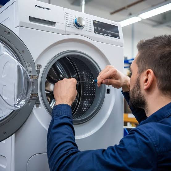 Appliance repair professional inspecting the drum of a front-loading washer
